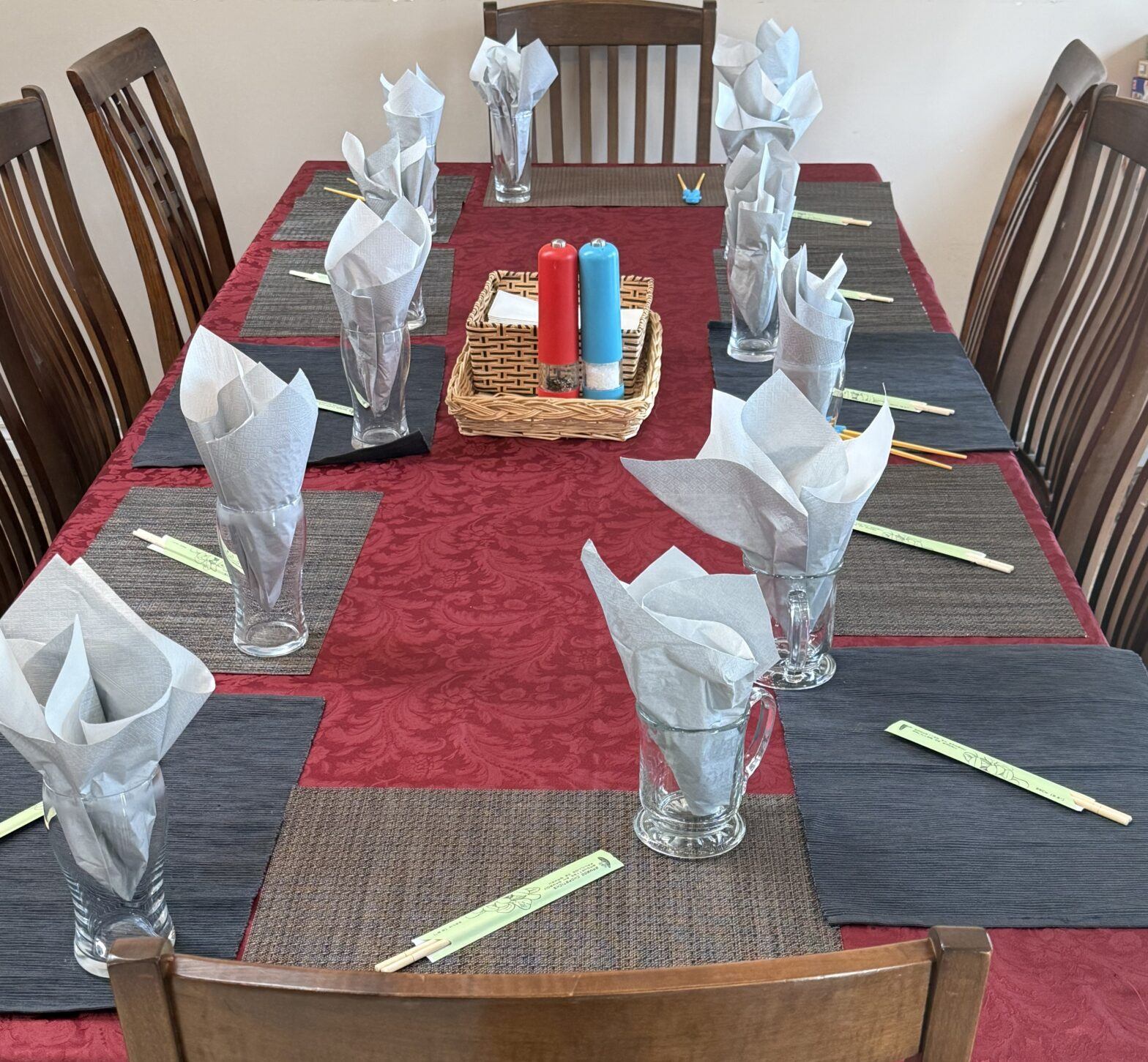 Dining table set with chopsticks at each place setting for a family Chinese food dinner for 14