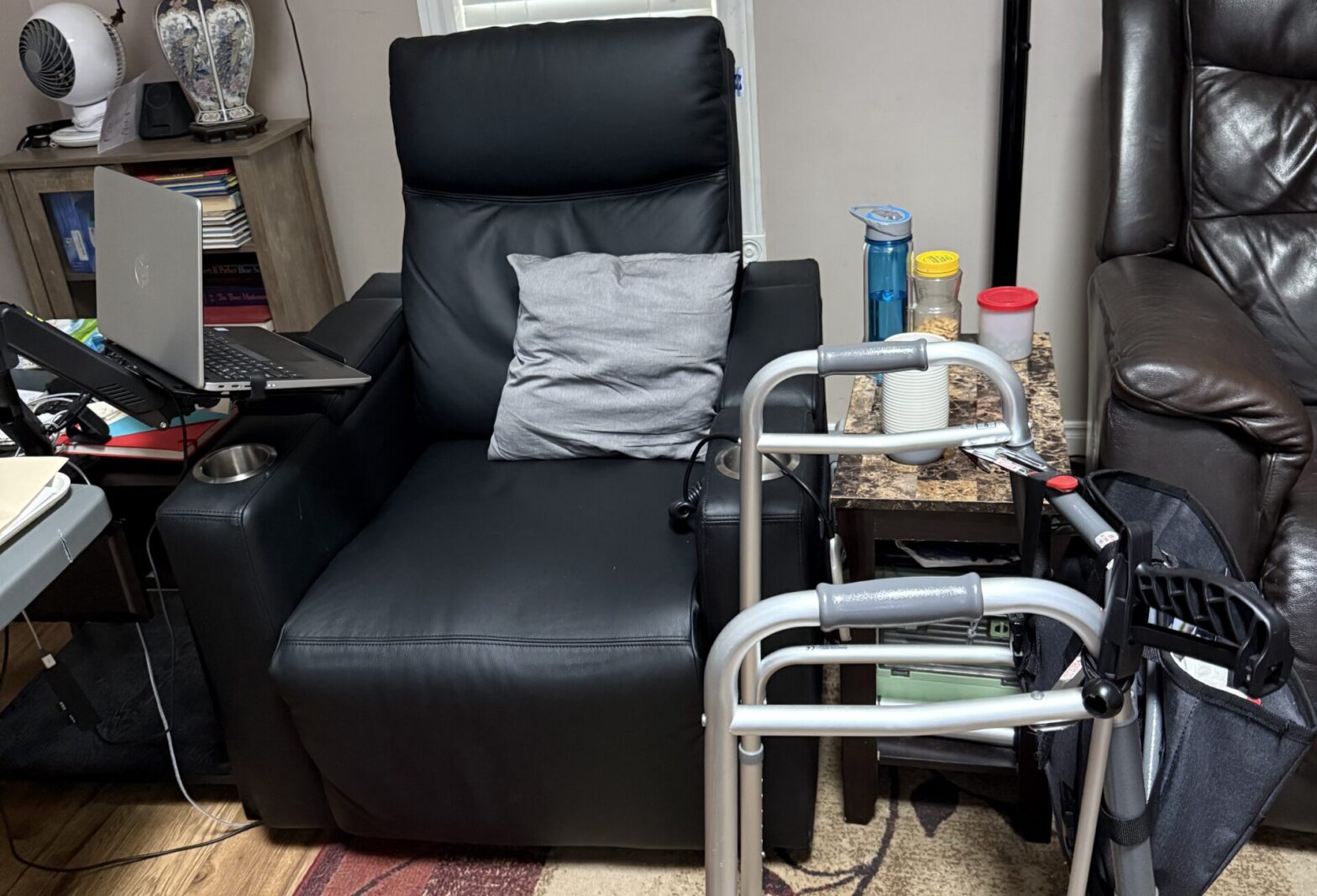 Power lift recliner, walker and laptop setup arranged in a living room for recovery after hip replacement surgery.