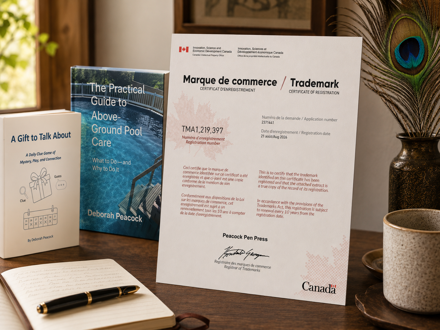 Peacock Pen Press Canadian trademark certificate displayed beside two published books