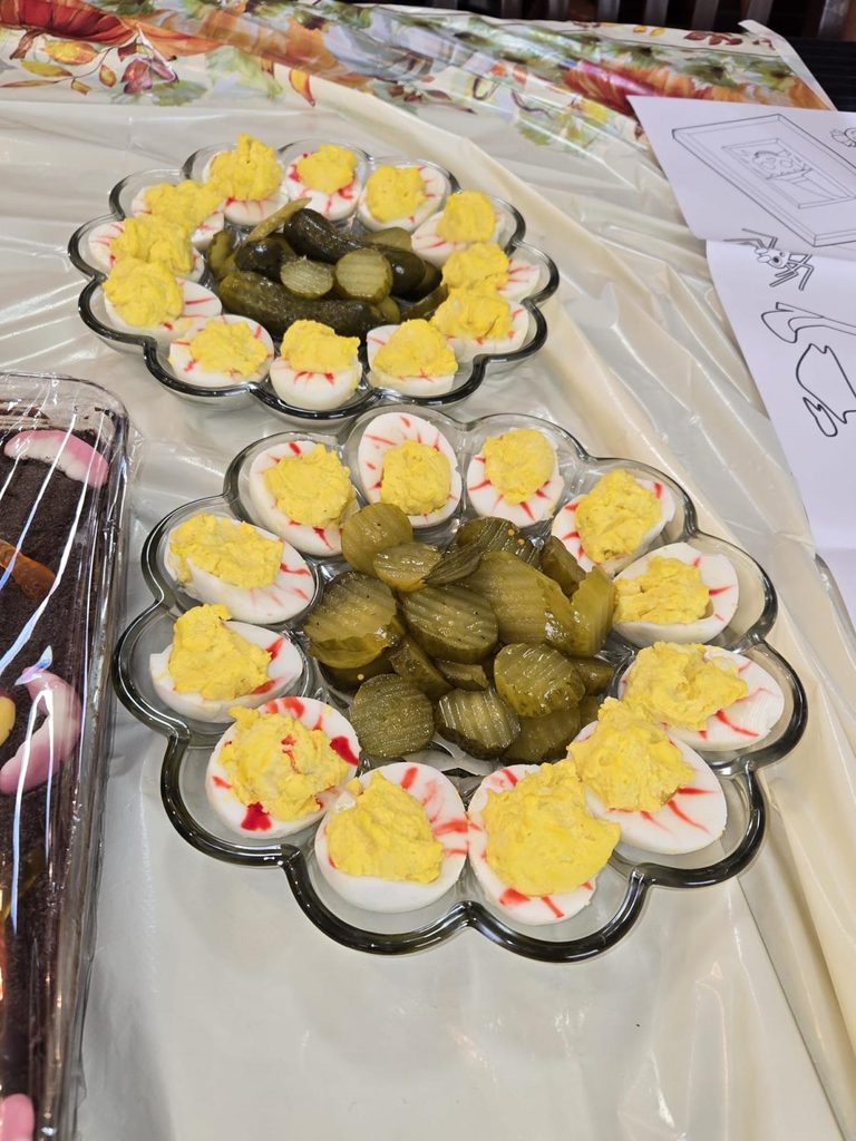 Devilled eggs with red streaks through the whites for a Halloween-themed Thanksgiving dinner.